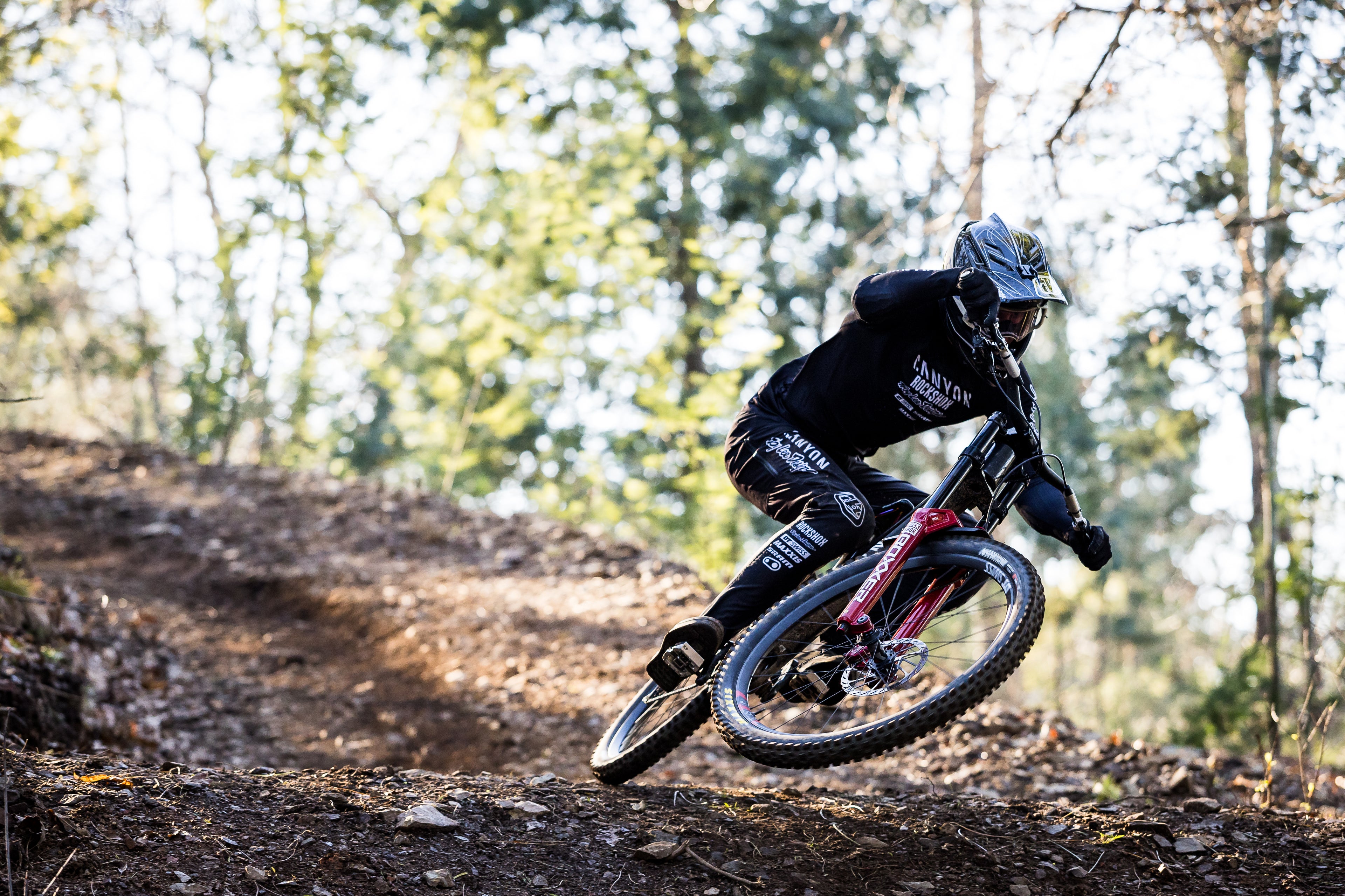 Rider going fast on the trail with his Canyon Sender downhill bike